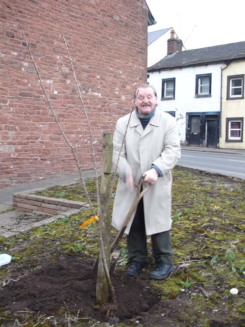 Roland Bateman planting a Cherry Tree